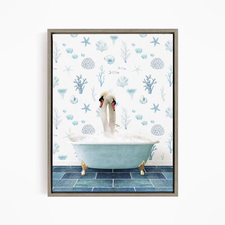 A framed image depicting a pair of swans sitting in a bathtub filled with bubbles, surrounded by a blue and white ocean-themed wallpaper.
