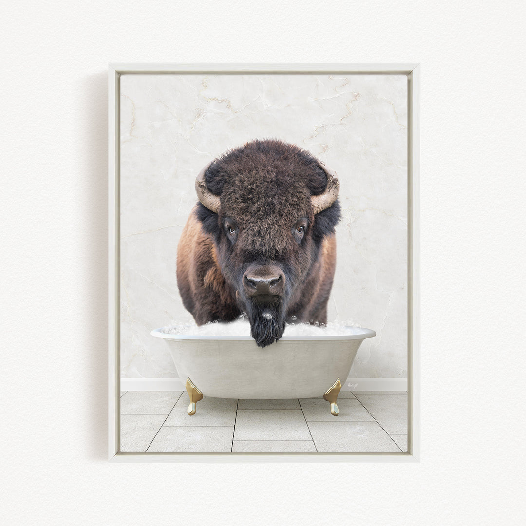 A buffalo with a long beard is standing in a white bathtub filled with water, looking directly at the camera.