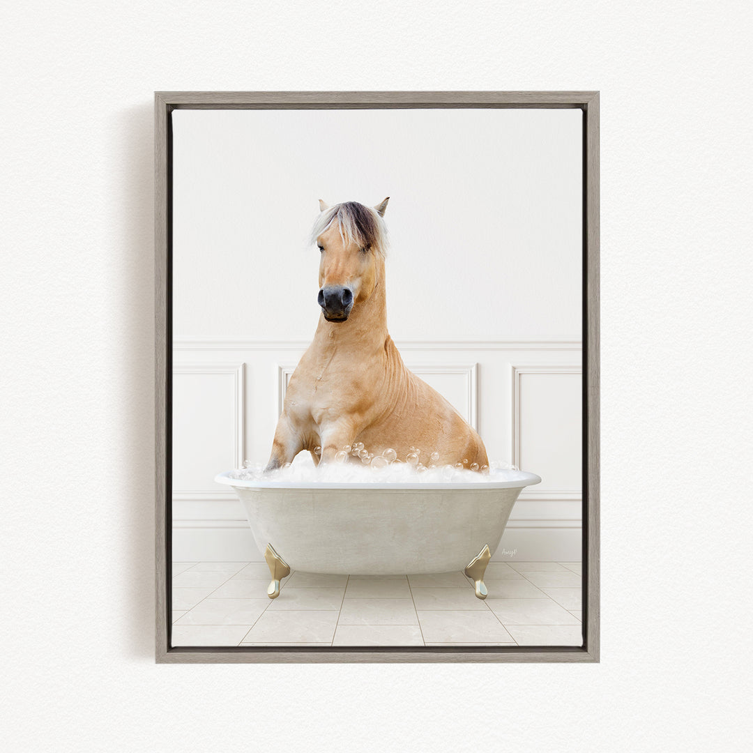 A light brown horse is sitting in a white bathtub filled with bubbles, creating a whimsical and playful scene.