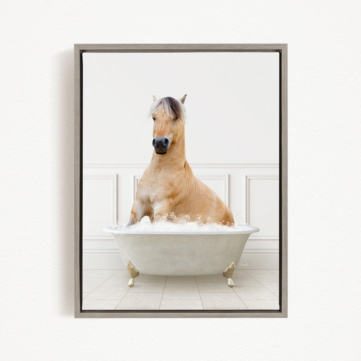A light brown horse is sitting in a white bathtub filled with bubbles, creating a whimsical and playful scene.