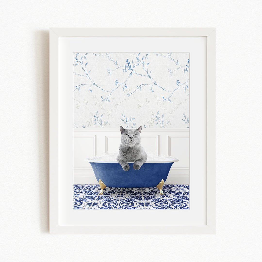 A gray cat sitting in a blue bathtub, with a patterned tile floor and a floral wallpaper in the background.