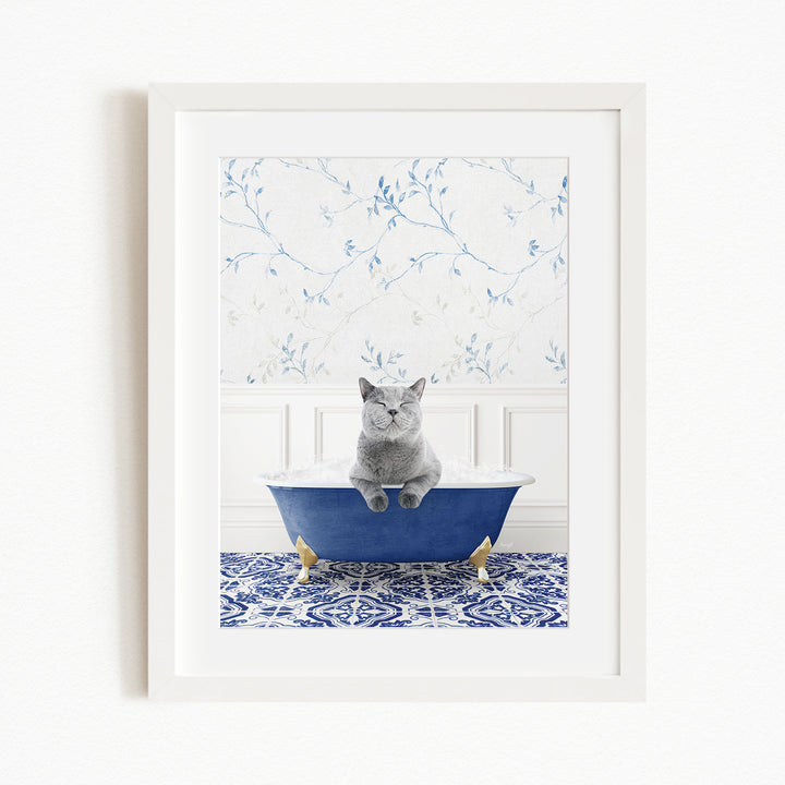 A gray cat sitting in a blue bathtub, with a patterned tile floor and a floral wallpaper in the background.