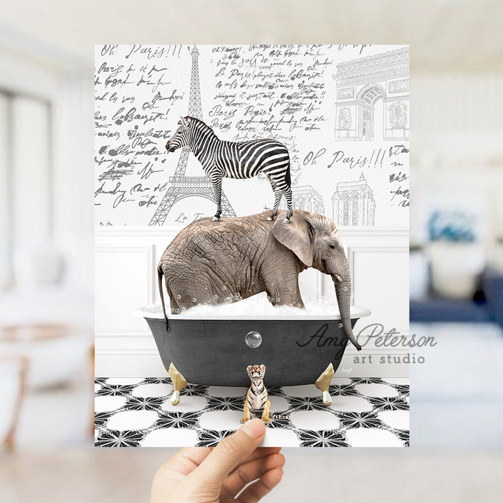 a person holding up a card with a picture of an elephant and a zebra