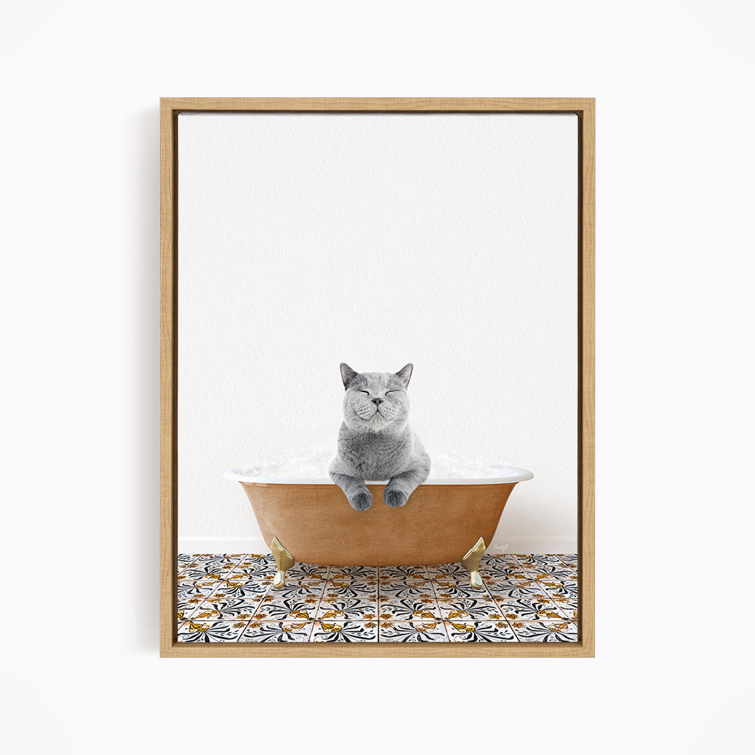 A gray cat sitting in a bathtub filled with bubbles, with a patterned tile floor beneath it.