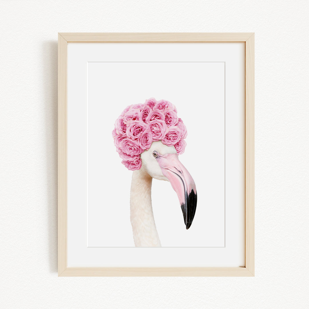 A framed image of a flamingo with a pink flower crown on its head.
