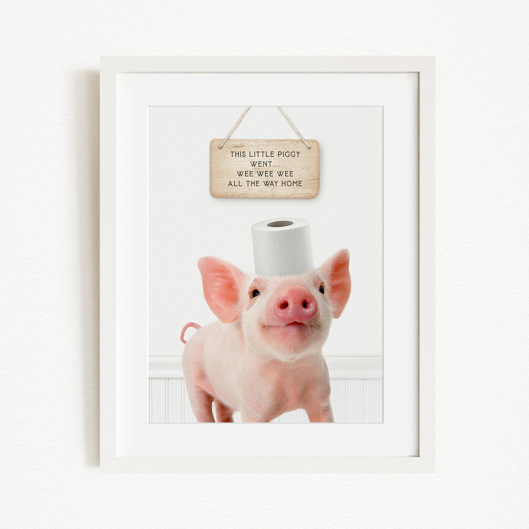 A framed image of a pig with a sign above it that reads "This little pig went weee weee weee all the way home".