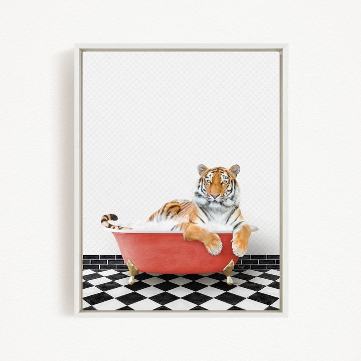 A tiger is sitting in a red bathtub on a black and white checkered floor.
