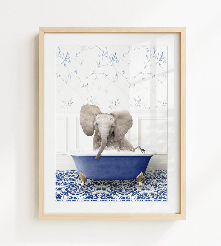 A gray elephant is sitting in a blue bathtub, surrounded by a patterned tile floor.
