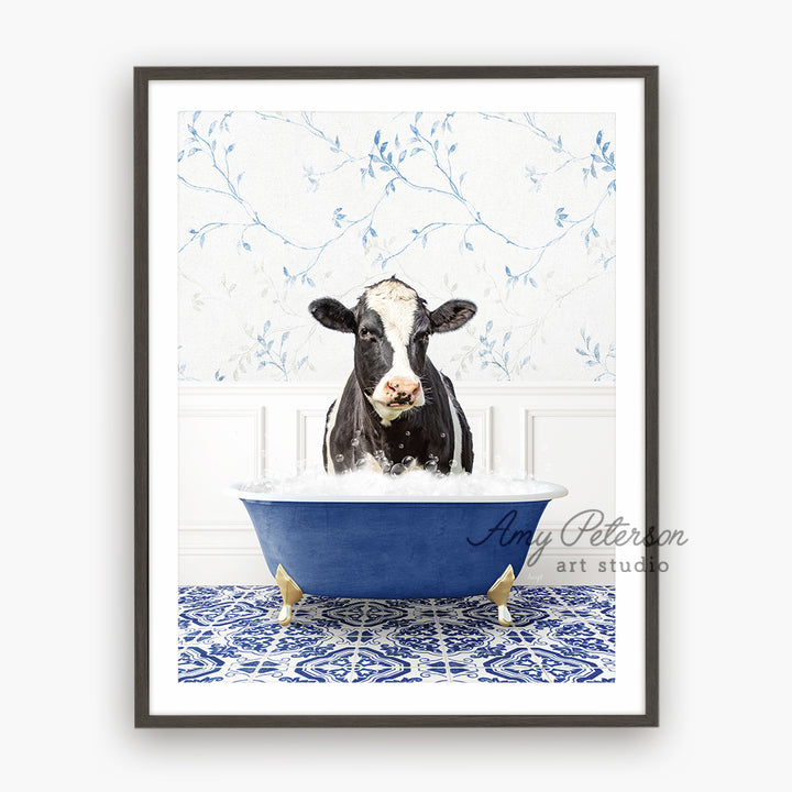 a black and white cow in a blue bathtub