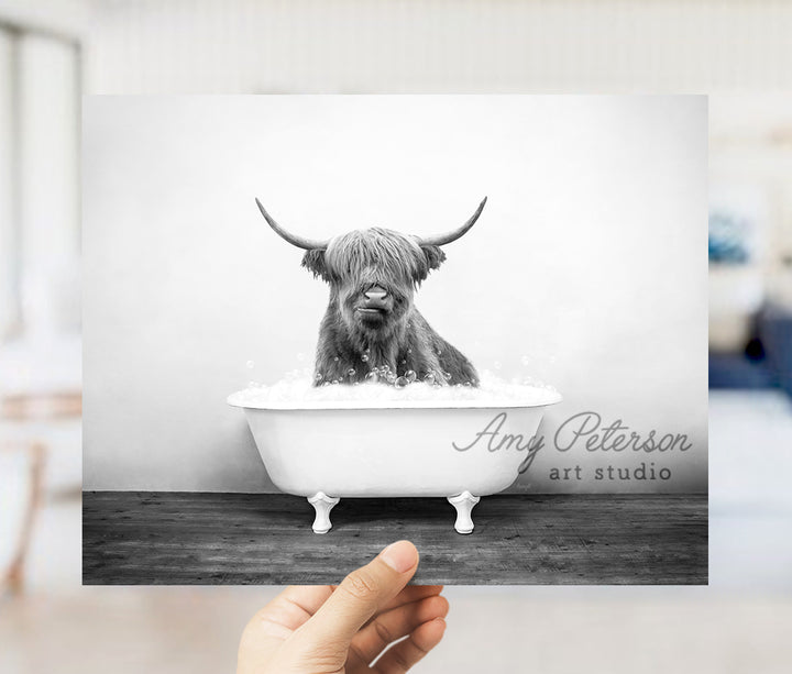 a black and white photo of a bull in a bathtub