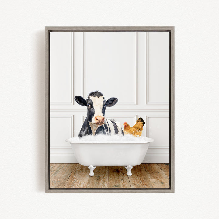 A black and white cow is sitting in a white bathtub filled with water, with a yellow chicken nearby.