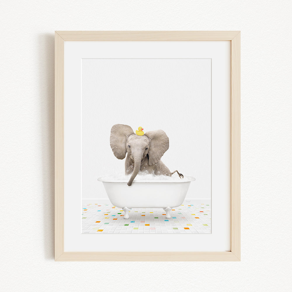 A baby elephant sitting in a white bathtub, with a yellow rubber duck floating on its head.