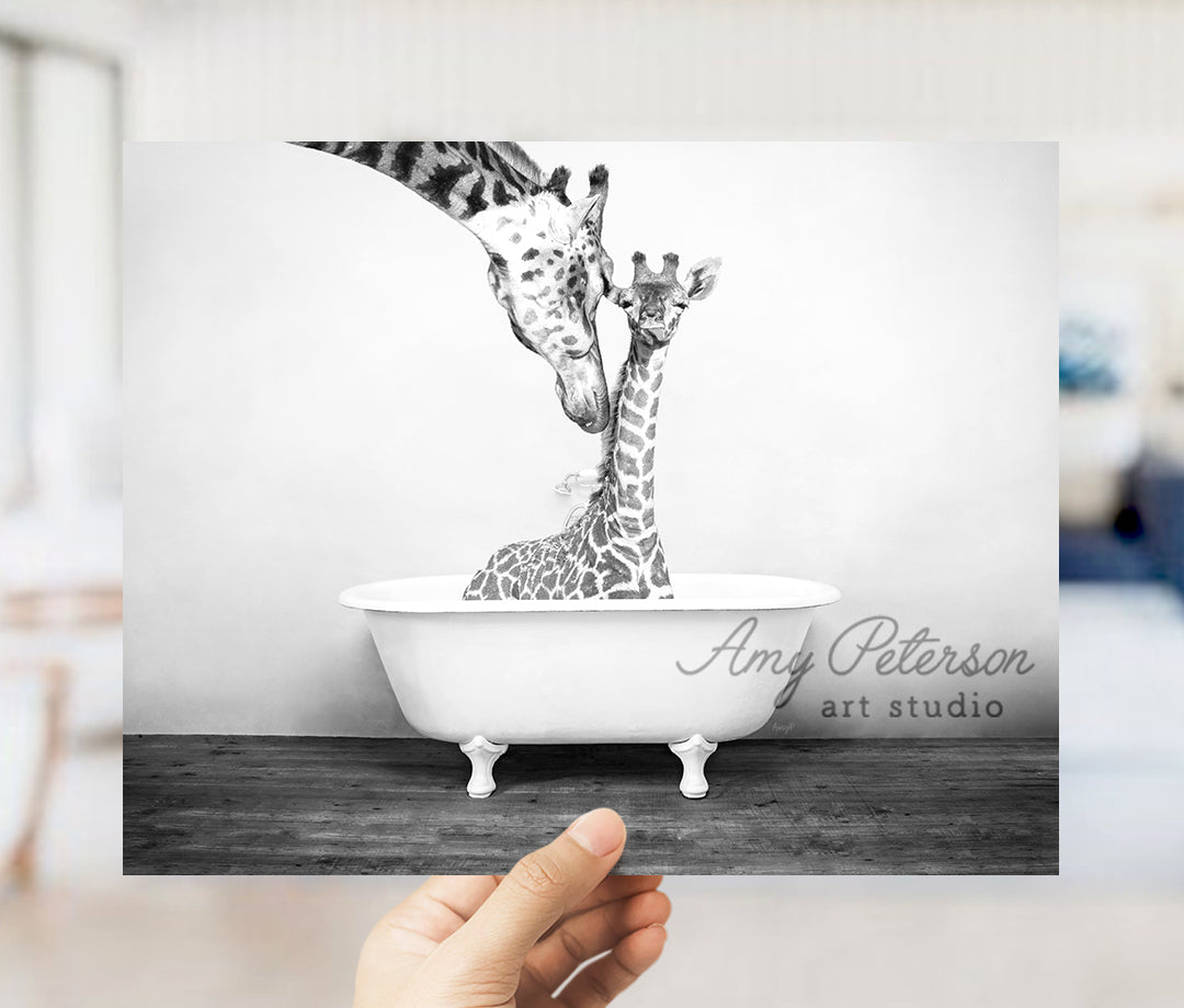 a hand holding up a picture of a giraffe in a bathtub