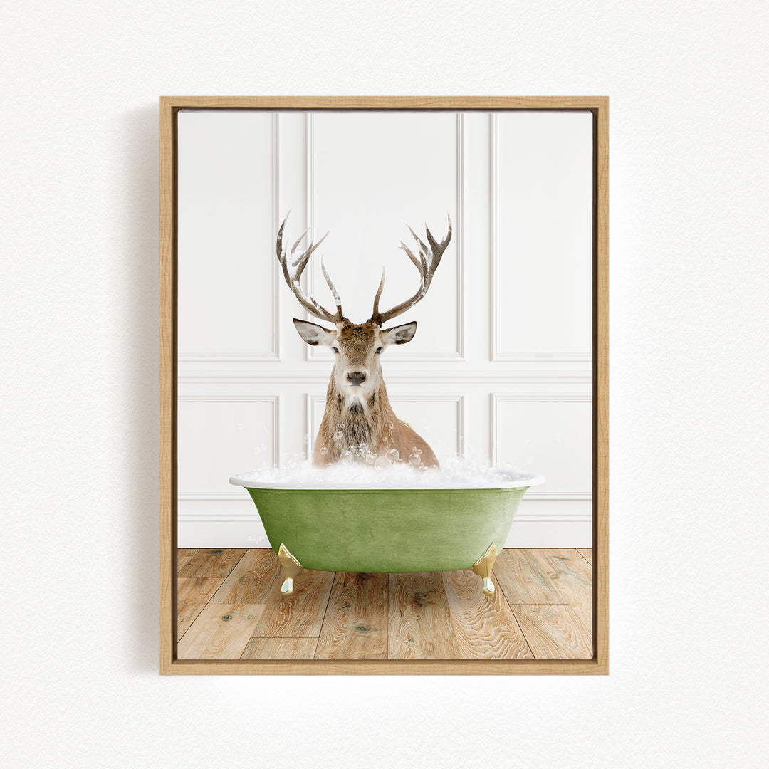 A deer with large antlers is sitting in a green bathtub filled with water, creating a whimsical and unexpected scene.