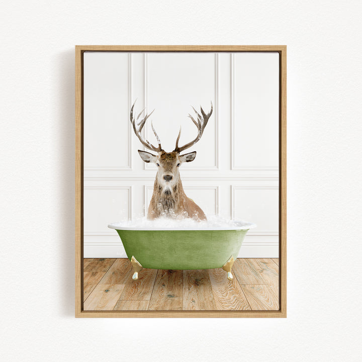 A deer with large antlers is sitting in a green bathtub filled with water, creating a whimsical and unexpected scene.