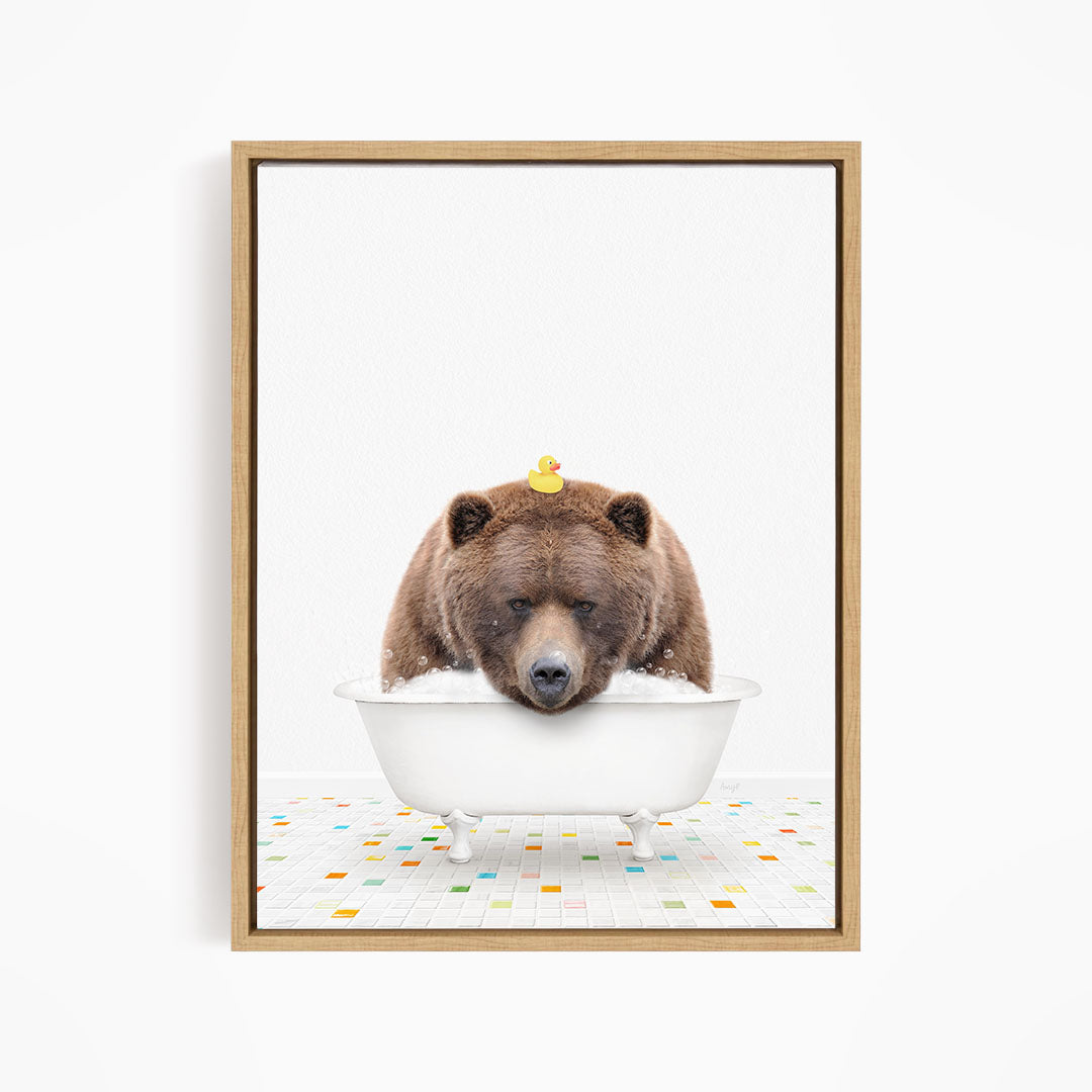 A brown bear is sitting in a white bathtub, with a yellow rubber duck perched on its head.