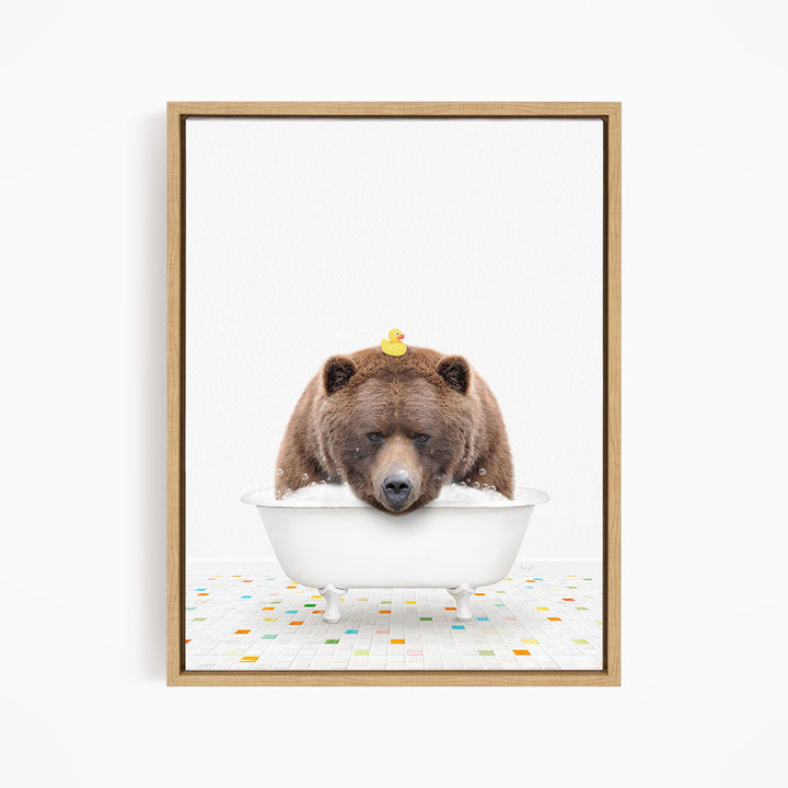 A brown bear is sitting in a white bathtub, with a yellow rubber duck perched on its head.