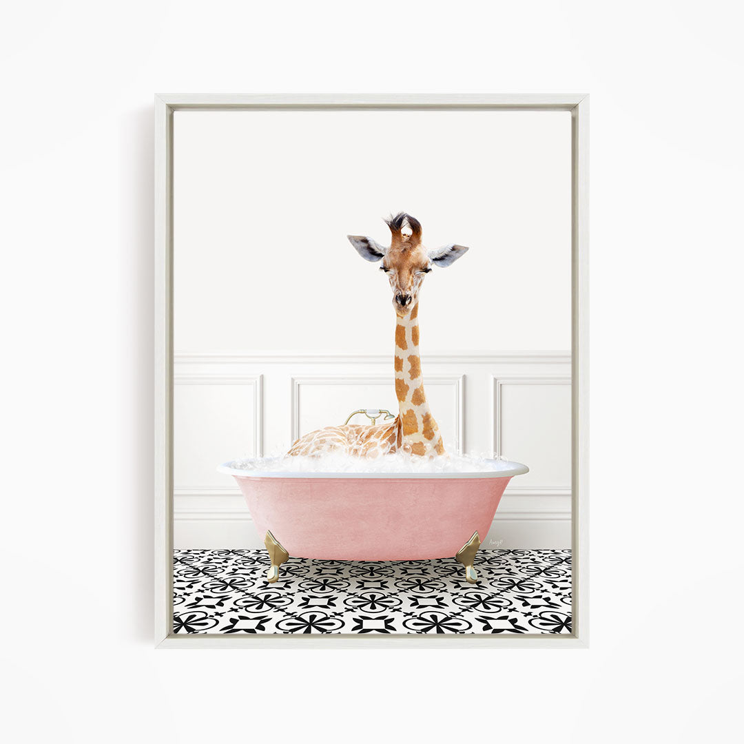A giraffe is sitting in a pink bathtub filled with bubbles, creating a whimsical and playful scene.
