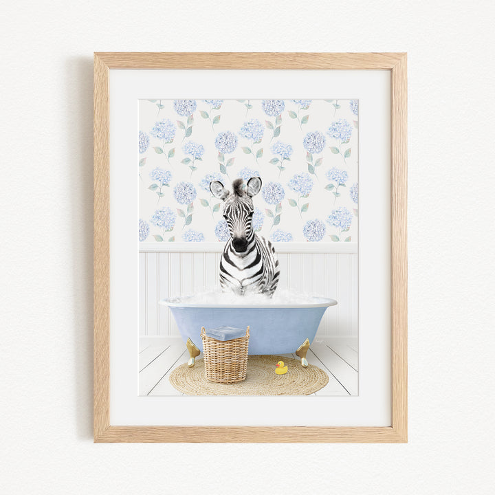 A zebra sitting in a blue bathtub filled with water, surrounded by a floral pattern on the wall behind it.