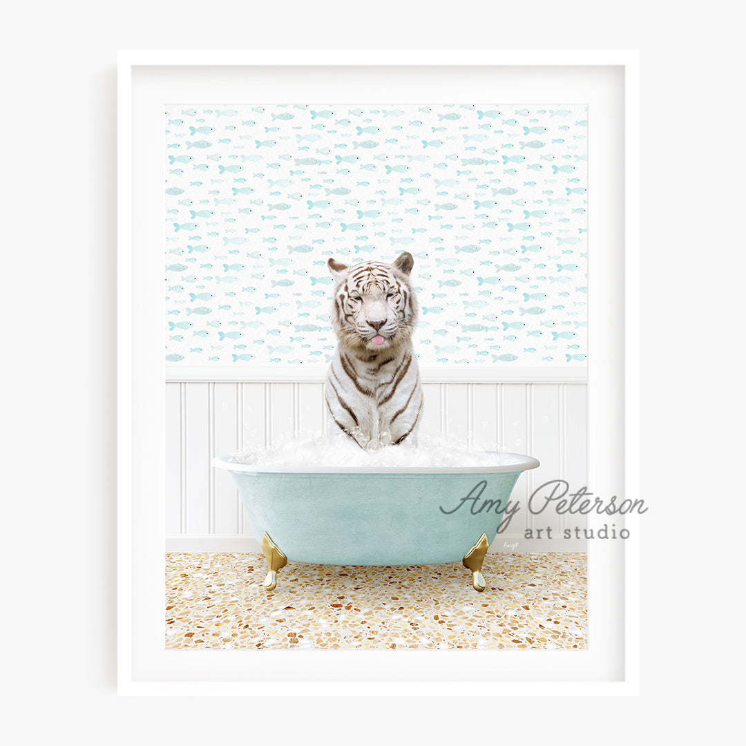 a white tiger sitting in a bath tub