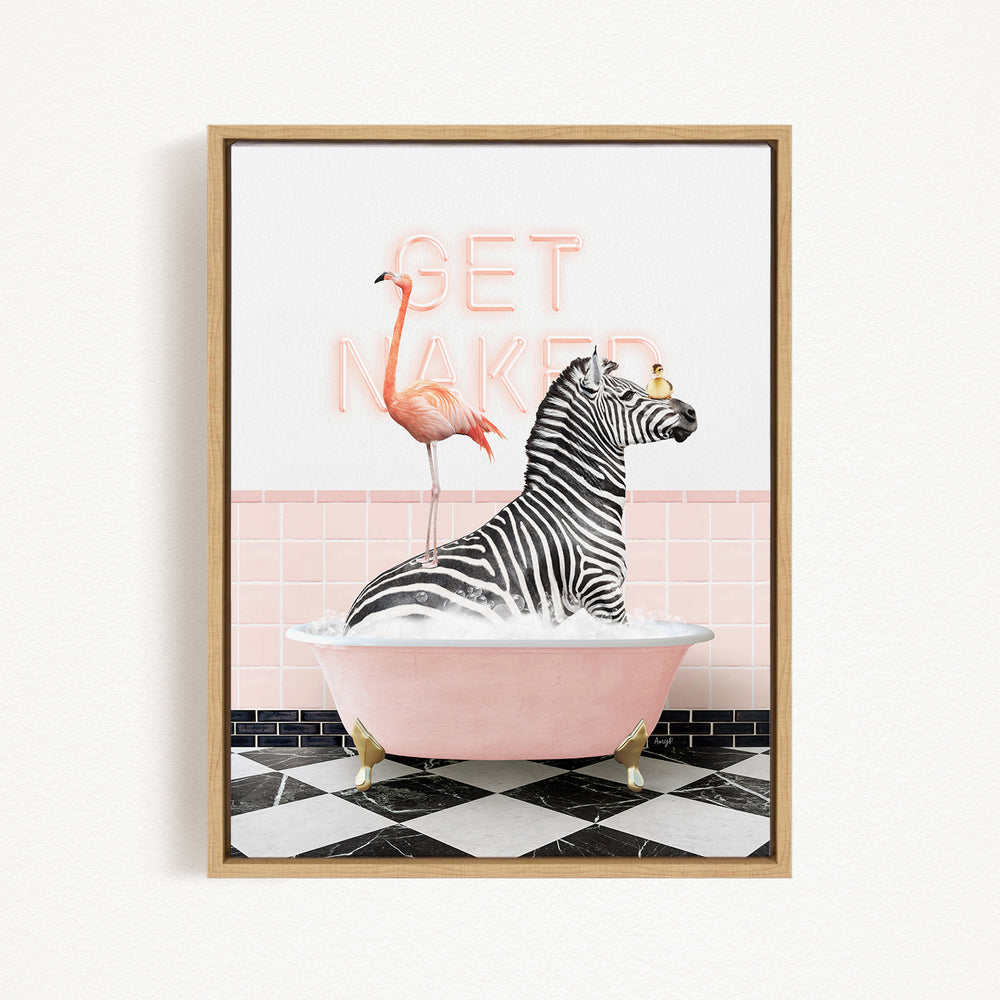 A framed image depicting a zebra sitting in a pink bathtub, with a flamingo standing on its back. The text "GET NAKED" is displayed above the scene.