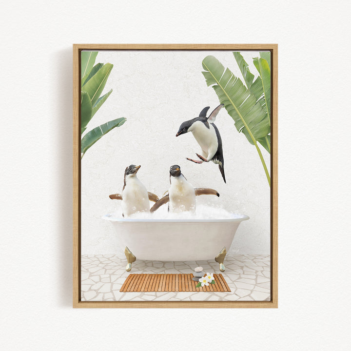 A framed image depicting three penguins sitting in a bathtub, surrounded by tropical plants.
