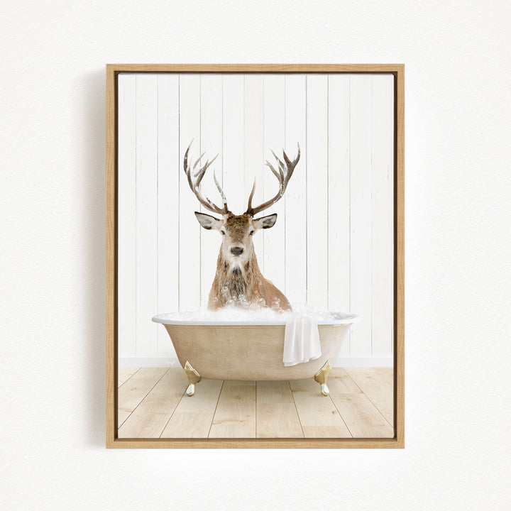 A deer with large antlers is sitting in a bathtub filled with water, creating a whimsical and unexpected scene.