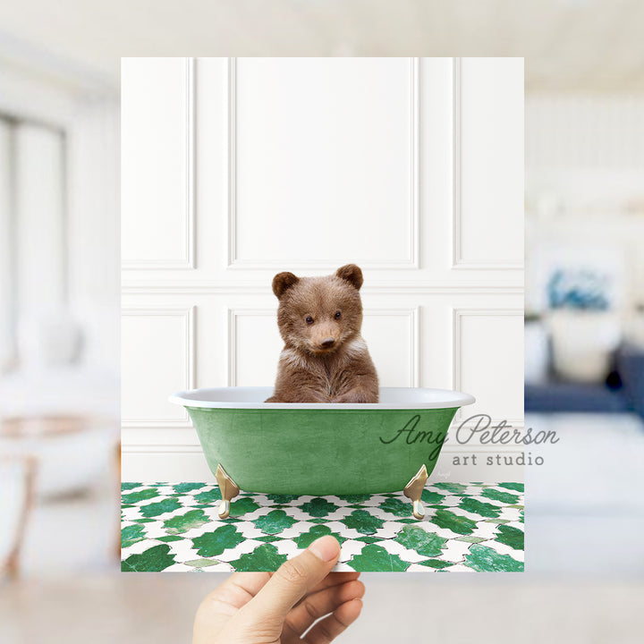 a small brown bear sitting in a green bath tub