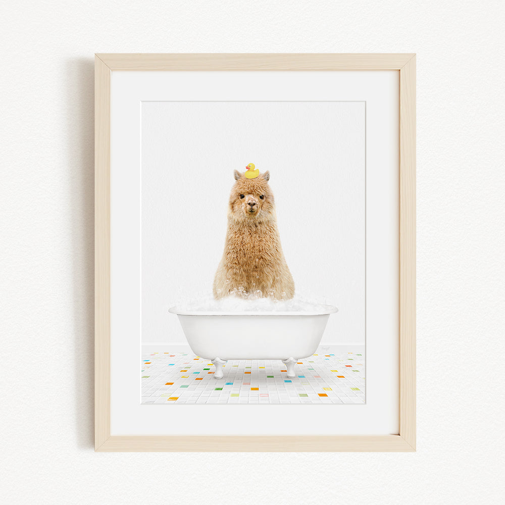 A fluffy brown dog sitting in a white bathtub filled with bubbles, wearing a yellow hat.