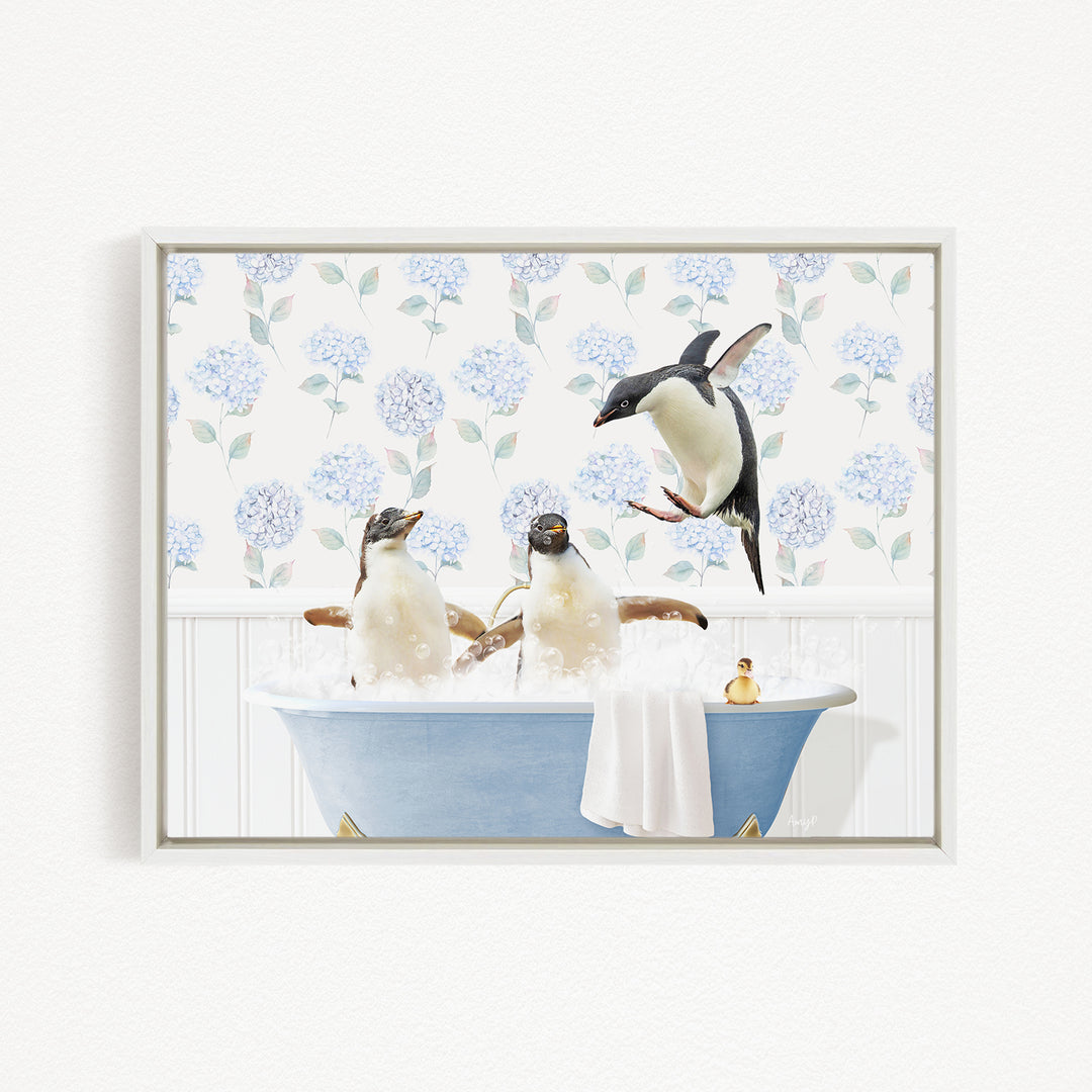 A framed image depicting three penguins sitting in a blue bathtub, with one penguin flying towards the tub.