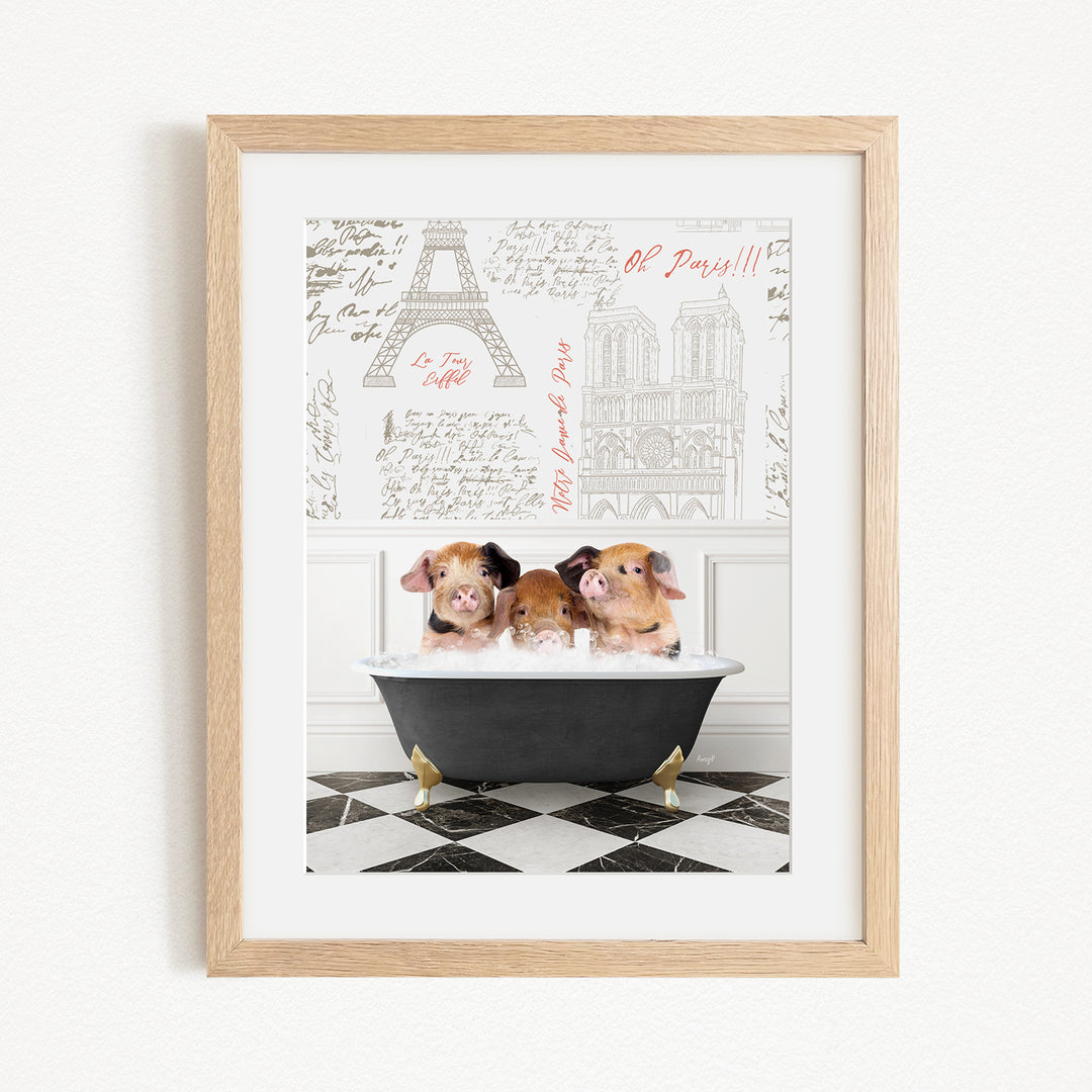 A framed image depicting three adorable pigs sitting in a bathtub, with a Paris-themed background featuring the Eiffel Tower and other Parisian landmarks.