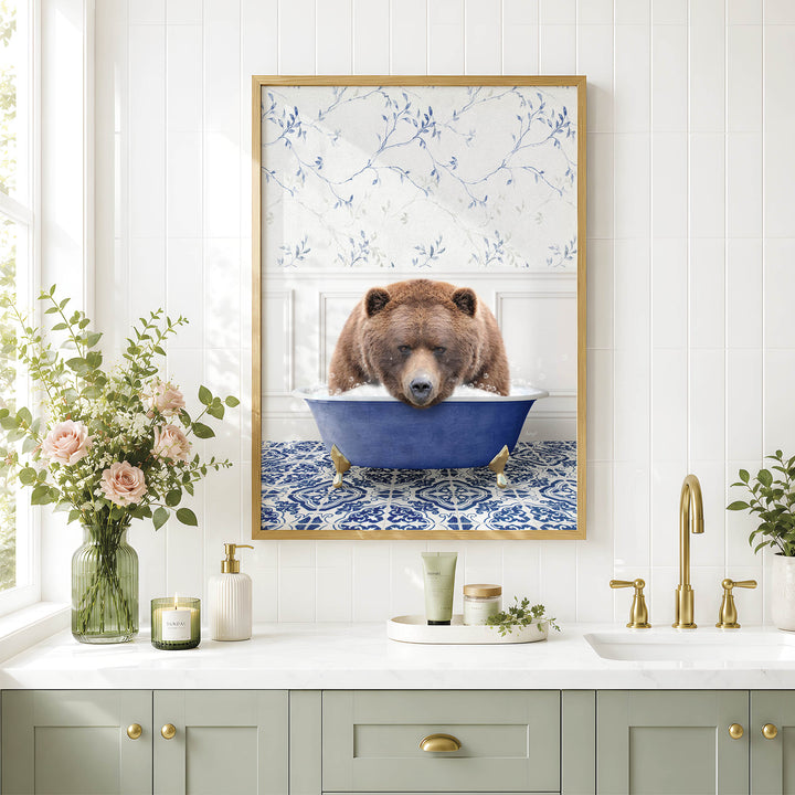 A framed image of a brown bear sitting in a blue bathtub, surrounded by flowers and a white and blue floral pattern on the wall.