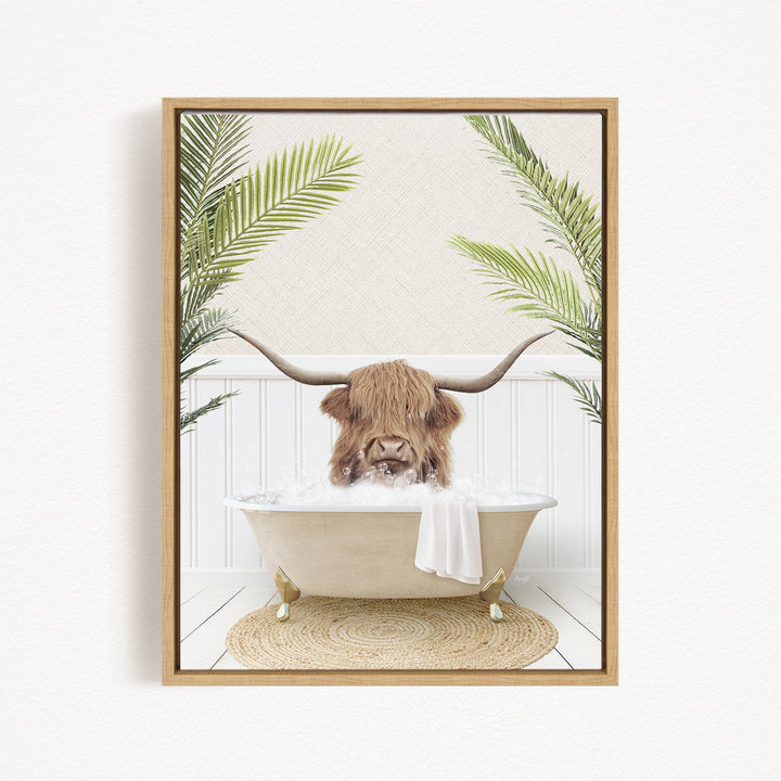 A brown cow with long horns is sitting in a bathtub filled with water, surrounded by green palm leaves.
