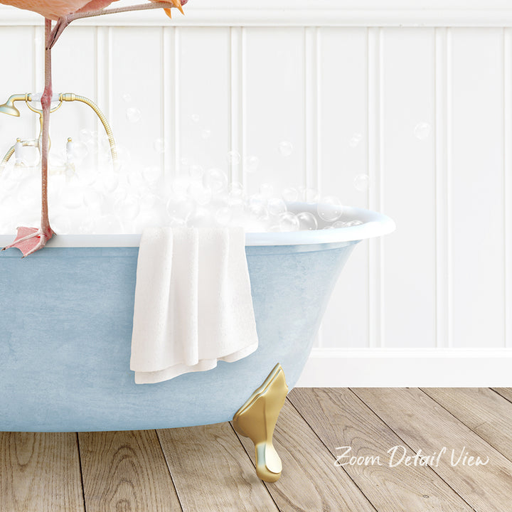 A blue claw-foot bathtub filled with bubbles, with a white towel hanging on the side and a gold bathtub leg visible.