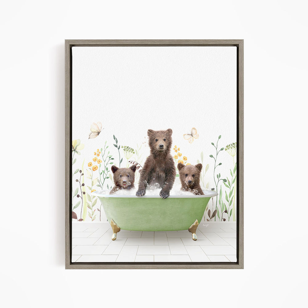 A framed print depicting three bears sitting in a green bathtub filled with water, surrounded by flowers and butterflies.