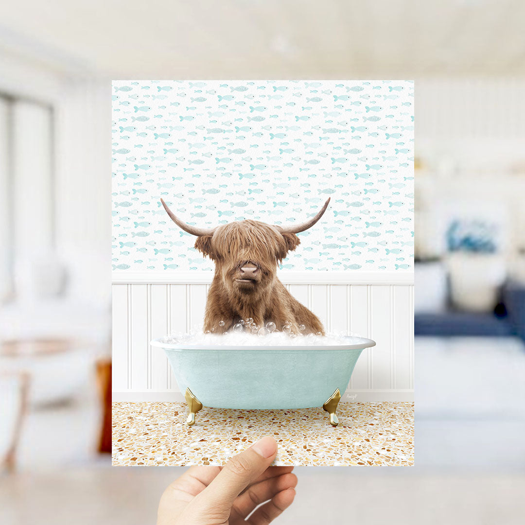 A brown cow with horns is sitting in a light blue bathtub filled with bubbles, surrounded by a pattern of fish.
