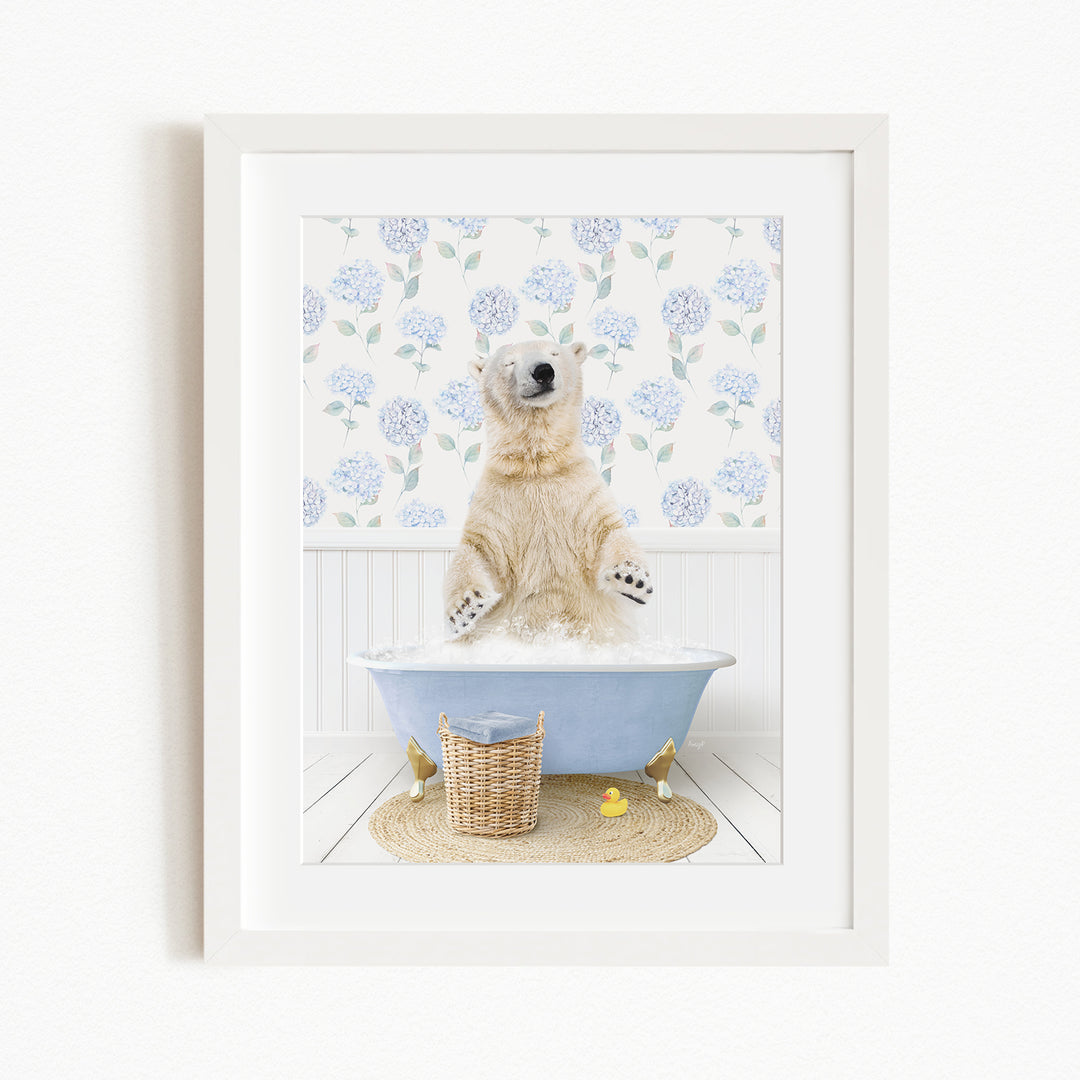 A polar bear standing in a blue bathtub filled with water, surrounded by a floral patterned wall and a basket of rubber ducks.