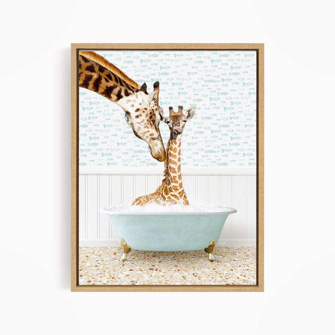 A mother giraffe and her baby giraffe are sitting together in a light blue bathtub, with the mother gently licking her baby.