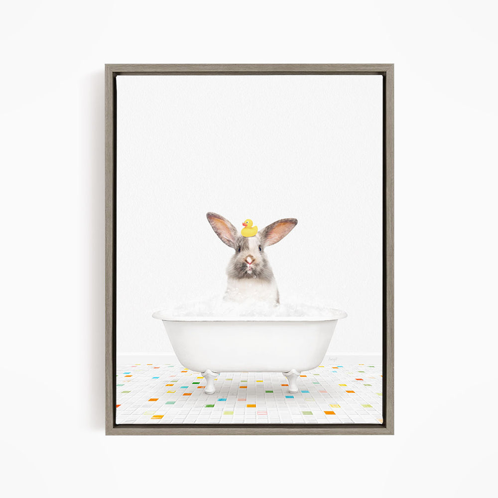 A white rabbit sitting in a white bathtub filled with bubbles, with a yellow rubber duck perched on its head.