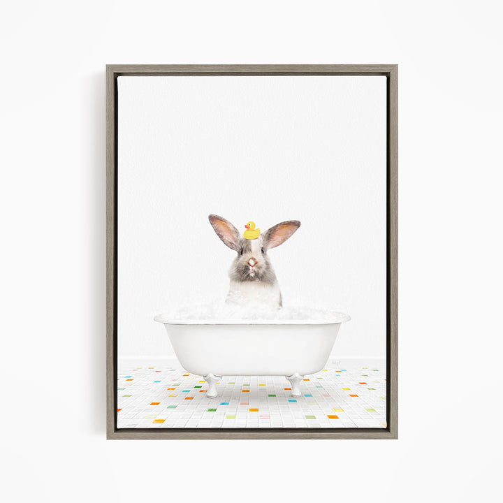 A white rabbit sitting in a white bathtub filled with bubbles, with a yellow rubber duck perched on its head.