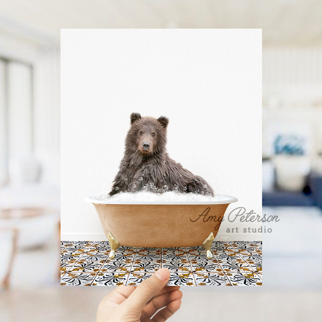 a hand holding a card with a picture of a bear in a bathtub