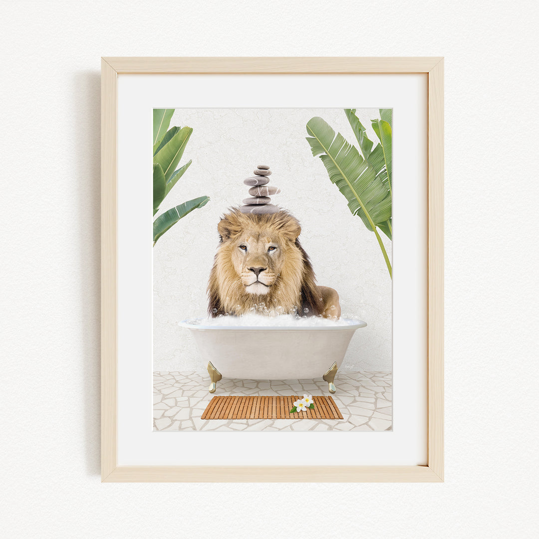 A framed image depicting a lion sitting in a bathtub filled with water, surrounded by tropical plants.