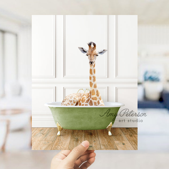 a hand holding up a card with a giraffe in a bathtub