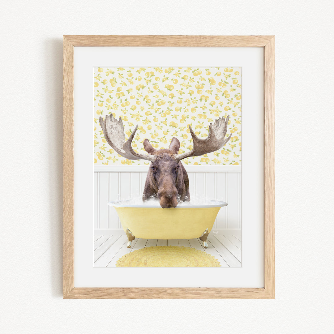 A moose with large antlers is sitting in a yellow bathtub, surrounded by a yellow and white floral pattern on the wall behind it.