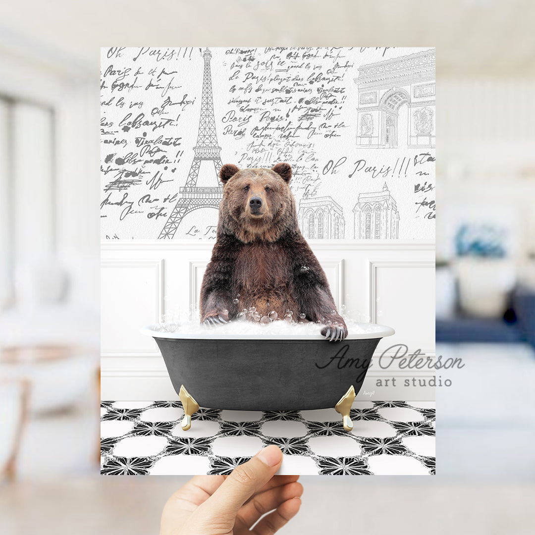 a person holding up a card with a bear in a bathtub