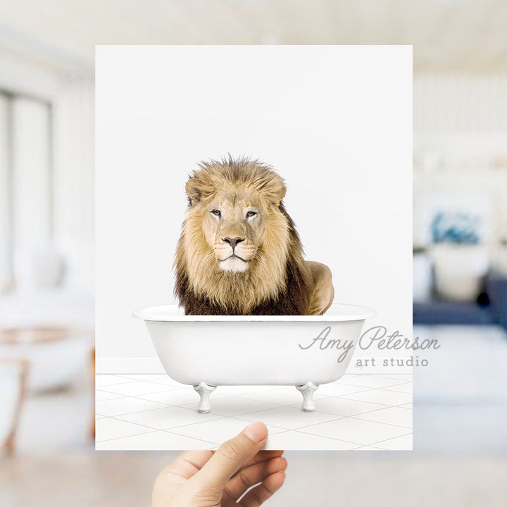 a hand holding a card with a picture of a lion in a bathtub