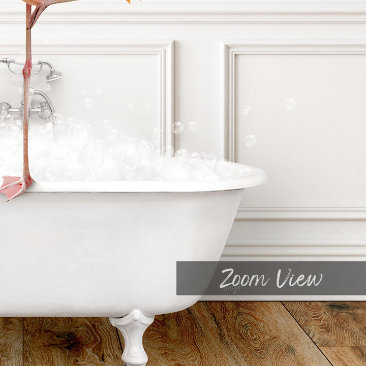 A white claw-foot bathtub filled with bubbles, with a pink flower attached to the side.