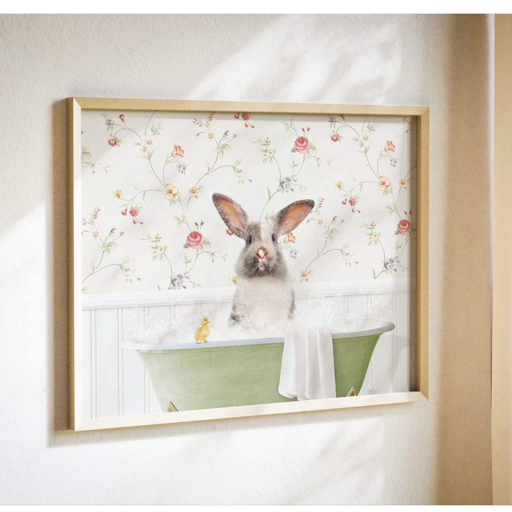 A framed image of a rabbit sitting in a bathtub filled with bubbles, with a yellow duck floating nearby.