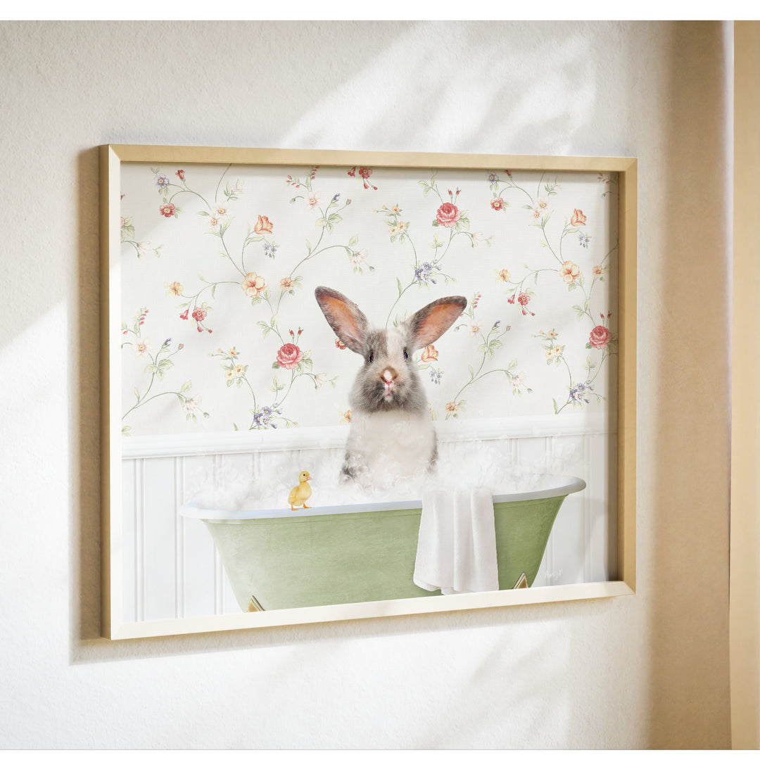 A framed image of a rabbit sitting in a bathtub filled with bubbles, with a yellow duck floating nearby.