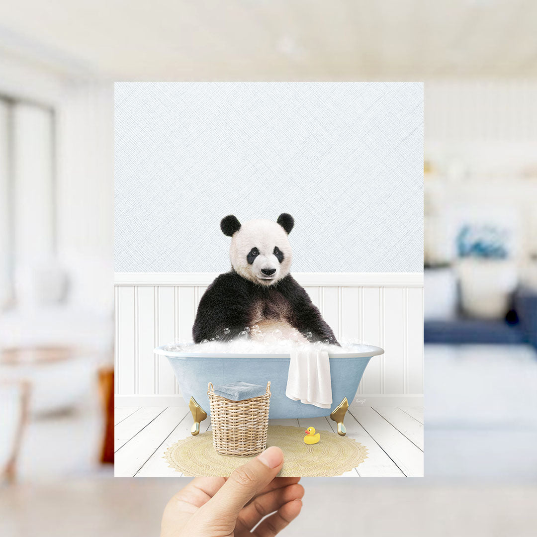 A panda bear sitting in a bathtub filled with bubbles, surrounded by a yellow rubber duck and a white towel.